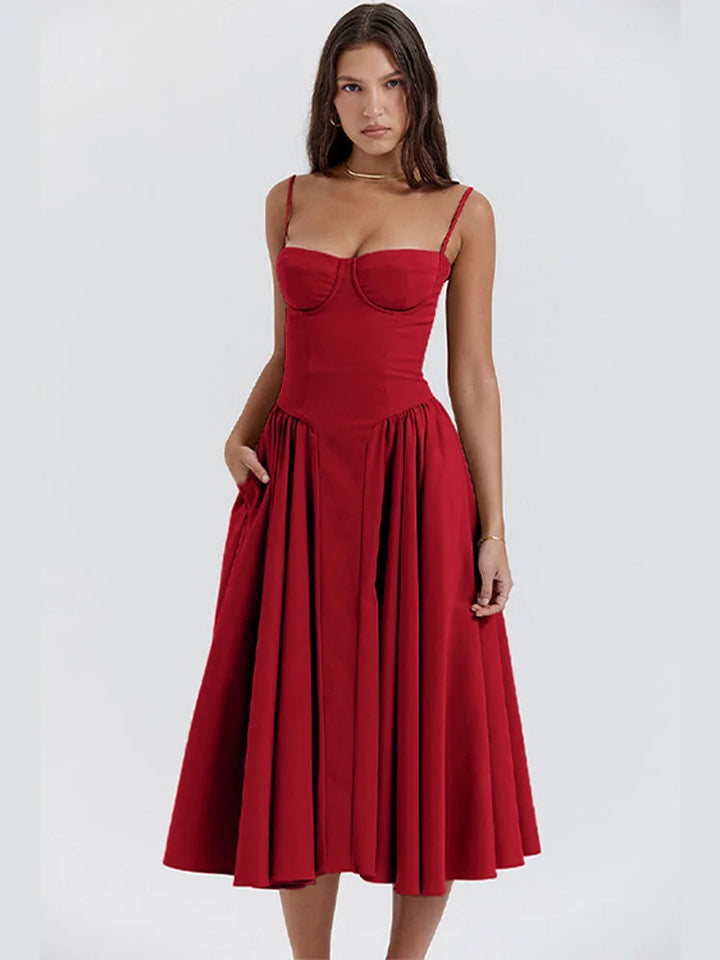 Red sundress with slimming bodice and flared skirt by Zamya in breathable cotton blend fabric. Sophisticated and flattering…