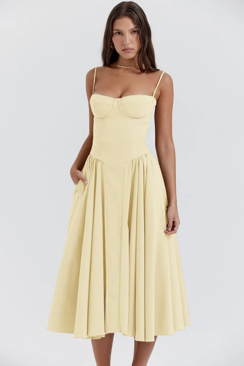 Yellow slimming bodice sundress with flared skirt by Zamya. Features button-up front, breathable fabric, and flattering…