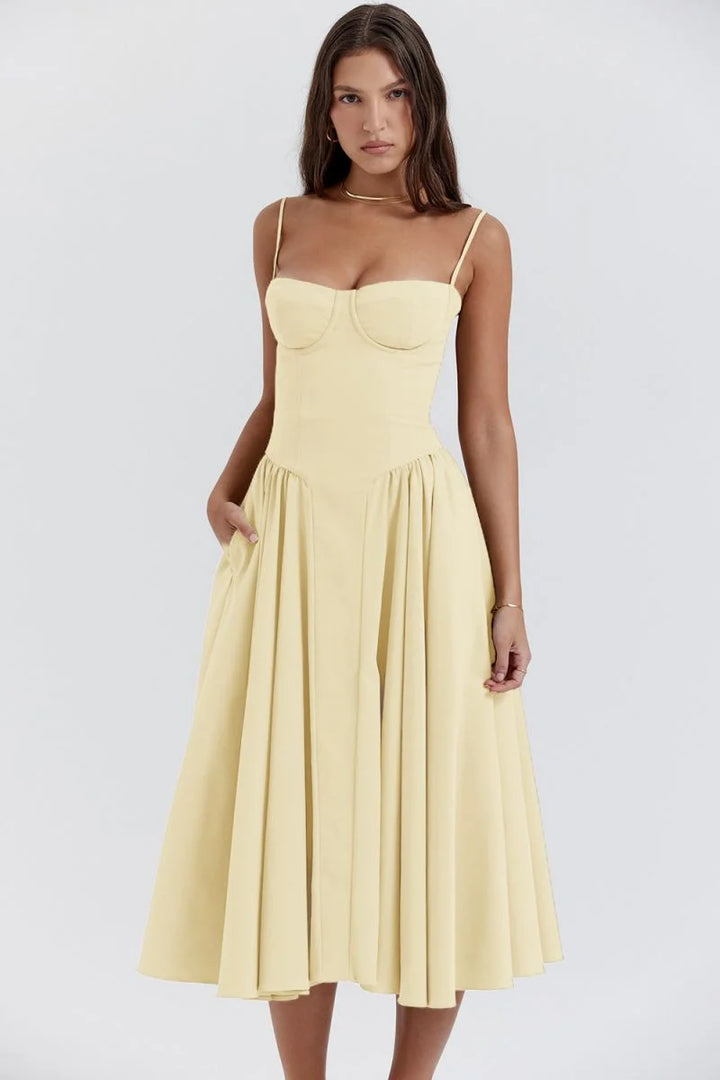 Yellow slimming bodice sundress with flared skirt by Zamya. Features button-up front, breathable fabric, and flattering…