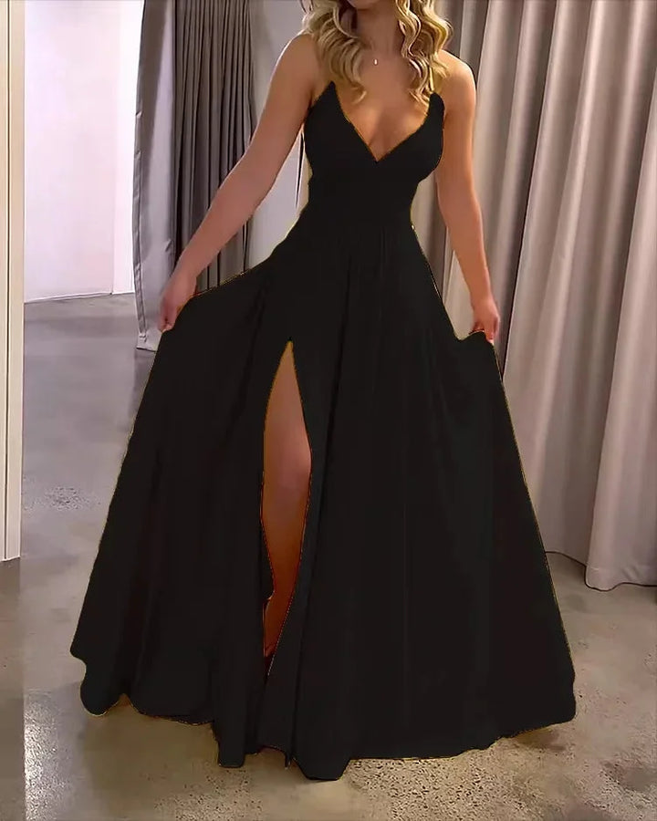 Black Imogene maxi dress with deep slit, made from flowing fabric. Features elegant design perfect for any occasion.