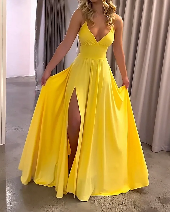Yellow Imogene maxi dress with deep slit, made from flowy fabric for a relaxed and elegant look.