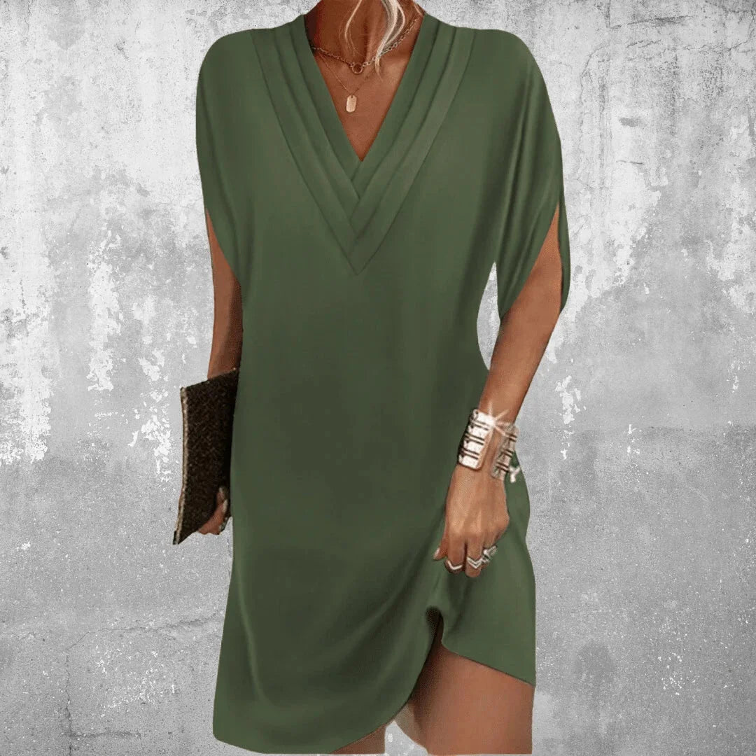 Military green Perry dress with V-neck and slit sleeves, made from soft, flowy fabric. Perfect for a chic and relaxed look.