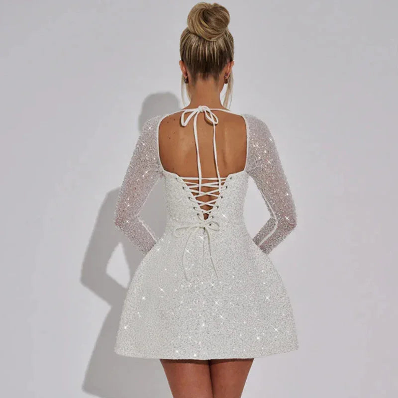 "Brilynn - Sparkling mini dress with sheer long sleeves in Stormy sequins and mesh fabric."