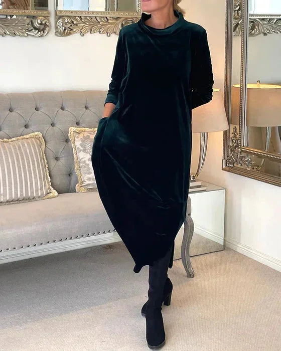 "Islah velvet midi dress in blue with side pockets, ribbed texture, and long sleeves for a chic and comfortable look."