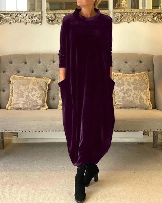 Purple Islah midi dress crafted in soft velvet with practical side pockets for a comfortable and stylish look.